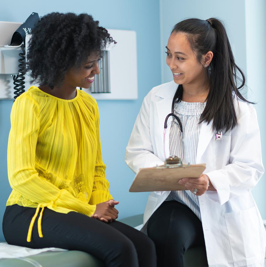 Ethnic woman in medical consultation with female doctor