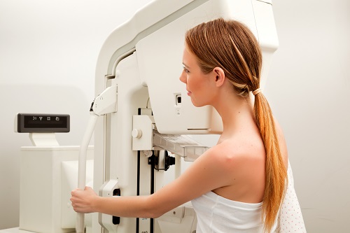 A young woman taking a mammogram x-ray test